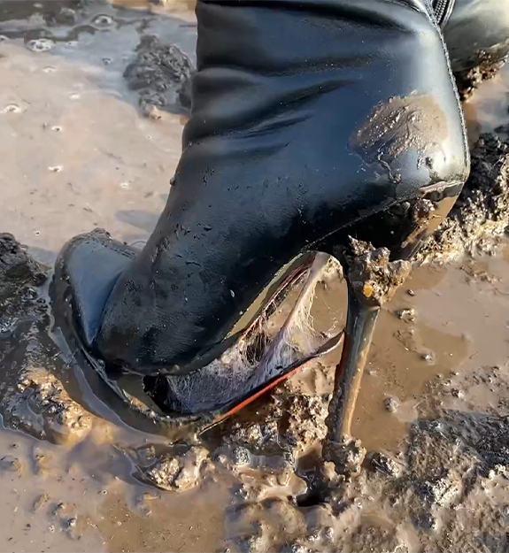 Alena walks through the mud in high heels ankle boots